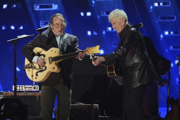 Stephen Stills, left, and Graham Nash perform during the FireAid benefit concert on Thursday, Jan. 30, 2025, at The Forum in Inglewood, Calif. (AP Photo/Chris Pizzello)